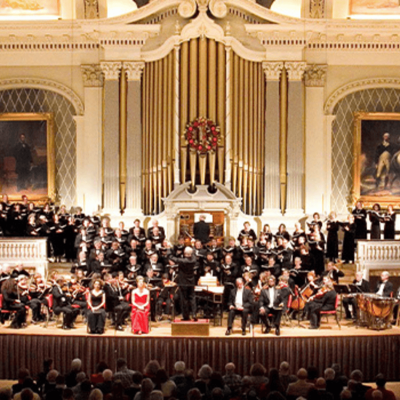 A large chorus on stage singing.