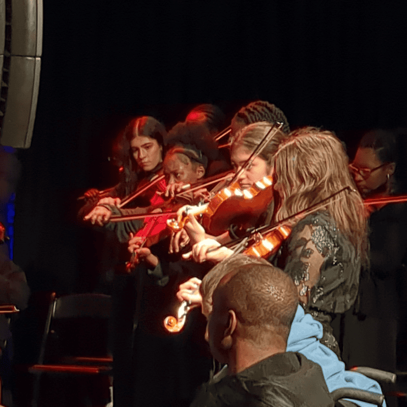 4 students playing violins