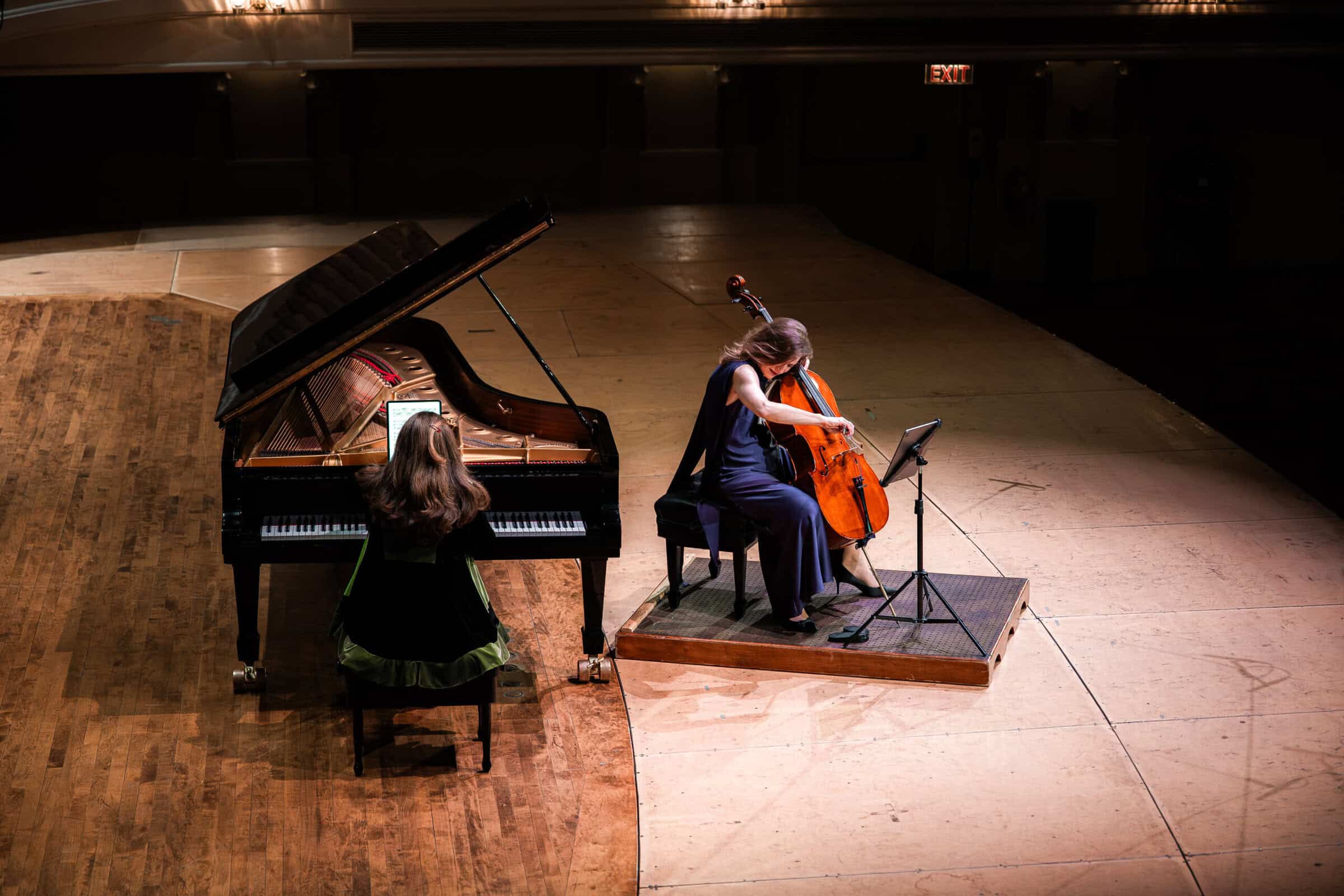 A pianist and cellist play on stage